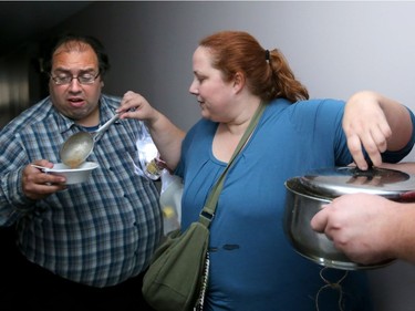 Volunteers hand out hot soup in the darkened hallways of a seniors residence in Nepean on Monday.