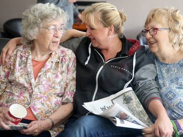 Raymond (centre) takes a moment amidst her flurry of activity to chat with seniors Marilyn Mallet, 85 (left), and Patricia Jansen VanBeek, 78, at a home in Nepean still without power .