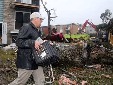 - Jamel Ben-Salem carries out some salvaged personal items from his family's home, which will more than likely be demolished as half the roof and side on the triplex was ripped off in the tornado. The family car sits upended under a tree (at right). Demolition started in the Mont-Bleu area of Gatineau Tuesday following the tornado that ripped through the housing development Friday. People could be found gathering up what little they could find in the remains of their homes as crews worked to demolish unsafe buildings and clean up debris.  Julie Oliver/Postmedia
