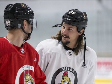 Ottawa Senators captain Erik Karlsson (R) talks with teammate Mikkel Boedker during an informal pre-training camp skate at the Bell Sensplex. September 11, 2018. Errol McGihon/Postmedia