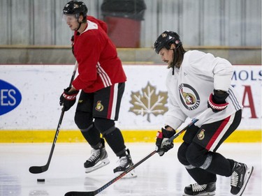 Ottawa Senators Thomas Chabot and Erik Karlsson (R) during an informal pre-training camp skate at the Bell Sensplex. September 11, 2018. Errol McGihon/Postmedia