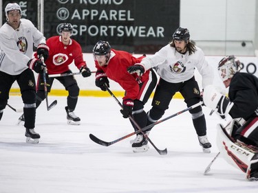 Ottawa Senators captain Erik Karlsson checks teammate Mikkel Boedker during an informal pre-training camp skate at the Bell Sensplex. September 11, 2018. Errol McGihon/Postmedia