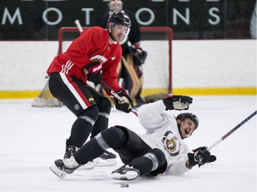 Ottawa Senators captain Erik Karlsson (R) gets knocked to the ice by teammate Mikkel Boedker during an informal pre-training camp skate at the Bell Sensplex. September 11, 2018. Errol McGihon/Postmedia