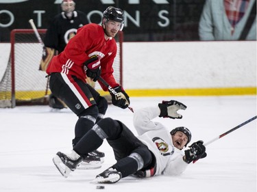 Ottawa Senators captain Erik Karlsson (R) gets knocked to the ice by teammate Mikkel Boedker during an informal pre-training camp skate at the Bell Sensplex. September 11, 2018. Errol McGihon/Postmedia