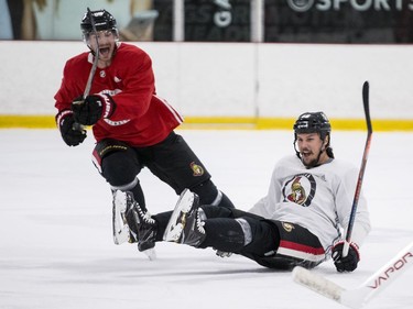 Ottawa Senators captain Erik Karlsson (R) gets knocked to the ice by teammate Mikkel Boedker during an informal pre-training camp skate at the Bell Sensplex. September 11, 2018.