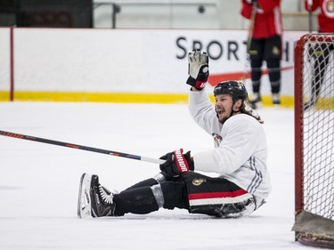 Ottawa Senators captain Erik Karlsson gets knocked to the ice by teammate Mikkel Boedker (not shown) during an informal pre-training camp skate at the Bell Sensplex. September 11, 2018. Errol McGihon/Postmedia