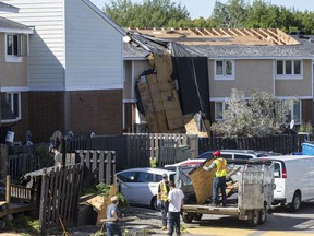 A crew helps with the cleanup from storm damage at the Quarry Co-op on McCarthy Road in Ottawa. September 22, 2018. Errol McGihon/Postmedia