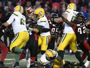 Edmonton Eskimos quarterback Mike Reilly loses control of the ball as he is sacked by Ottawa Redblacks linebacker Kyries Hebert during Saturday's game.