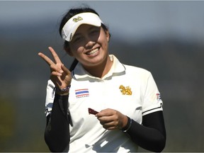 There was good reason for Atthaya Thitikul of Thailand to smile as a final-round 60, setting a new course record, gave her the individual title in the world junior championship at Camelot Golf and Country Club. Bernard Brault/Golf Canada