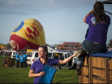 Hot air balloon chasers Marie-Josee Berube and Tamy Vallerand prepare their balloon for launch.