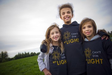 From left, six-year-old Ella Vivone, 12-year-old Mariana Runia and six-year-old Julia Runia wearing their Can't Dim My Light t-shirts.
