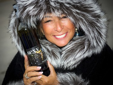 Michelle Begin, owner of Valley Flowers, was well bundled with her bottle of wine and fur to stay warm.