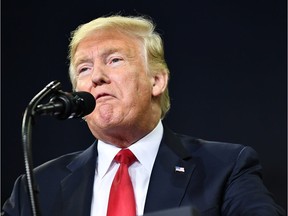 (FILES) In this file photo taken on August 30, 2018 US President Donald Trump speaks during a campaign rally at Ford Center in Evansville, Indiana. - President Donald Trump responded September 5, 2018 to a damning book about his presidency by journalist Bob Woodward by suggesting that Congress change US libel laws."Isn't it a shame that someone can write an article or book, totally make up stories and form a picture of a person that is literally the exact opposite of the fact, and get away with it without retribution or cost," Trump tweeted."Don't know why Washington politicians don't change libel laws?"The tweet was Trump's latest reaction to "Fear," Woodward's account of a "crazytown" White House in the grip of an angry, unhinged president whose aides scurry to keep him from blundering into war and other disasters.