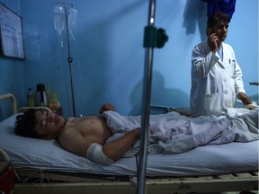 Wounded Afghan wrestler Ali Seena, 20, receives treatment at Isteqlal hospital in Kabul on Sept. 6, 2018, after a suicide attack on the Maiwand Club that targeted wrestlers during a training session. At least 20 people were killed including two Afghan journalists in the blasts.