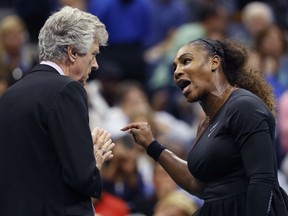 Serena Williams talks with referee Brian Earley during the women's final of the U.S. Open tennis tournament against Naomi Osaka of Japan on Saturday in New York.