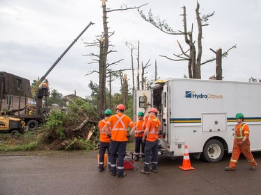 Hydro workers on Parkland Cres as Arlington Woods continues to be a beehive of activity with arborists, hydro workers and city crews continuing to repair the damage from Friday's tornado.