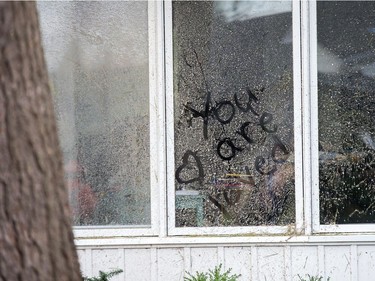 A touching message left in sawdust on the window of a home as Arlington Woods continues to be a beehive of activity with arborists, hydro workers and city crews continuing to repair the damage from Friday's tornado.