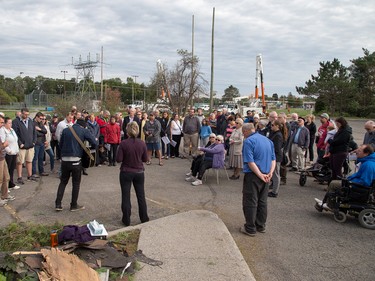 Pastor Mike Hogeboom adresses his congregation outside Arlington Woods First Methodist Church on Sunday morning as residents in Ottawa's Arlington Woods neighbourhood deal with the aftermath of the twister that touched down on Friday afternoon.
