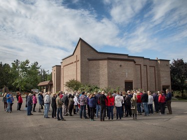 Pastor Mike Hogeboom adresses his congregation outside Arlington Woods First Methodist Church on Sunday morning as residents in Ottawa's Arlington Woods neighbourhood deal with the aftermath of the twister that touched down on Friday afternoon.