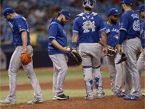 While filling in for the outgoing John Gibbons as manager, Blue Jays catcher Russell Martin takes relief pitcher Joe Biagini, left, out of the game in the eighth inning on Sunday.