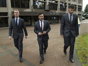 Craig Stoner, Simon Radford, and Joshua Finbow, left to right, British sailors charged with sexual assault causing bodily harm while visiting for a hockey tournament earlier in the year, head from Nova Scotia Supreme Court in Halifax on Wednesday, August 12, 2015. The men are being permitted to fly home to their families in the United Kingdom while on bail pending a preliminary inquiry scheduled for next April in Halifax provincial court.