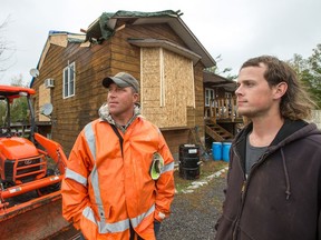 Calabogie residents Clinton Leclaire (L) and Mitchell Strader outside their home, (Mitchell rents a room) that suffered significant damage when the tornado struck the region on Friday. Photo by Wayne Cuddington/ Postmedia