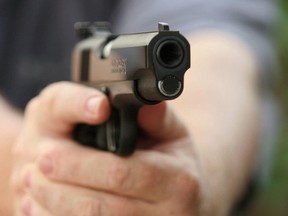 An unidentified man holds a Colt .45 semi-automatic pistol in Manassas, Virginia, 22 July, 2007.