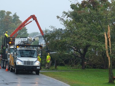 Workers clear fallen trees along Charing Road in Ottawa that was severely damaged by the recent tornado. September 25,2018. Errol McGihon/Postmedia