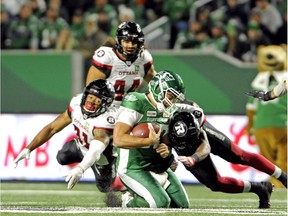 Roughriders quarterback Zach Collaros goes down under a pile of Redblacks defenders during the second half of Saturday's game in Regina.