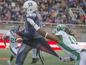 Saskatchewan defensive back Ed Gainey fouls Montreal receiver Adarius Bowman during the first half of Sunday's game, earning a pass-interference penalty.