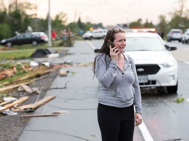 Christy Jarvis outside the home of her cousin before learning that the people inside had been rescued and taken to hospital as a reported tornado touched down in Dunrobin in the far west end of Ottawa.