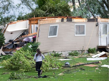 Christy Jarvis rushes to the home of her cousin before learning that the people inside had been rescued and taken to hospital as a reported tornado touched down in Dunrobin in the far west end of Ottawa. Wayne Cuddington/ Postmedia