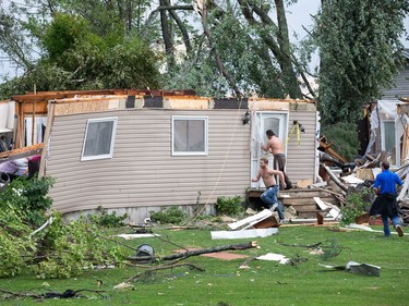 Neighbours rush to a home destroyed by the reported tornado but they soon learned that firefighters had already rescued the people inside as a reported tornado touched down in Dunrobin in the far west end of Ottawa. Wayne Cuddington/ Postmedia