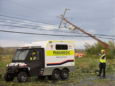 A paramedic vehicle is off loaded as a reported tornado touched down in Dunrobin in the far west end of Ottawa. Wayne Cuddington/ Postmedia