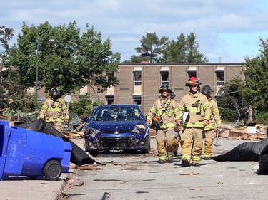 Firefighters survey damaged apartment buildings in Gatineau, Que.