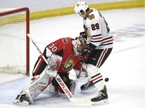 Senators goaltender Filip Gustavsson looks for the puck past Blackhawks forward Andreas Martinsen during the second period of Friday's game.