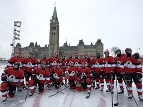 The Ottawa Senators pose for a team photo on the Canada 150 Rink on Parliament Hill, ahead of the NHL 100 Classic in Ottawa on Friday, Dec. 15, 2017.