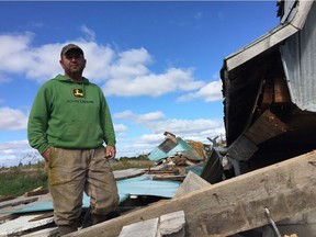 Jim Flewellyn with the remains of his barn near Kinburn. The entire structure had been moved off its foundation and deposited about three metres away.