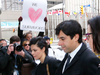 Jian Ghomeshi rushes by protesters during his sex assault trial in Feb. 2016.