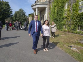 New Brunswick Liberal Leader Brian Gallant and wife Karine Lavoie, right, leave a press conference following meeting with Lieutenant Governor of New Brunswick Jocelyne Roy-Vienneau, in Fredericton on Tuesday, Sept. 25, 2018.