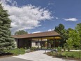 The entryway is practically unrecognizable from the original with a new extended front porch, landscaping and textured elements like wooden slacks and a jagged concrete path.