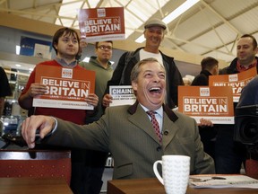 Vice-chairman of Brexit pressure group Leave Means Leave, Nigel Farage, relaxes with supporters in the market area of Bolton, England, during a campaign stop, Saturday Sept. 22, 2018. With barely six months until Britain's Brexit split with the European Union, the Leave Means Leave group are working to gather supporters to their cause.
