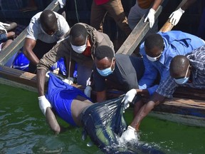 Rescuers retrieve a body from the water near Ukara Island in Lake Victoria, Tanzania Friday, Sept. 21, 2018. The death toll rose above 100 after the passenger ferry MV Nyerere capsized on Lake Victoria, Tanzania state radio reported Friday, while a second day of rescue efforts raced the setting sun. (AP Photo)