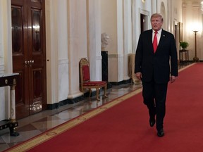 FILE - In this Wednesday, Sept. 12, 2018 file photo, President Donald Trump arrives to speak at a Congressional Medal of Honor Society reception in the East Room of the White House in Washington. Trump is going ahead with plans to announce new tariffs on about $200 billion of Chinese imports, The Wall Street Journal reported Saturday, Sept. 15, 2018.