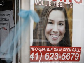 In this Aug. 21, 2018, file photo, a poster for missing University of Iowa student Mollie Tibbetts hangs in the window of a local business in Brooklyn, Iowa.