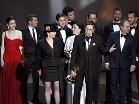 Amy Sherman-Palladino, front and center left, Daniel Palladino and the cast and crew of "The Marvelous Mrs. Maisel" accept the award for outstanding comedy series at the 70th Primetime Emmy Awards on Monday, Sept. 17, 2018, at the Microsoft Theater in Los Angeles.