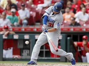 Los Angeles Dodgers' Joc Pederson hits a solo home run off Cincinnati Reds starting pitcher Anthony DeSclafani in the fourth inning of a baseball game, Wednesday, Sept. 12, 2018, in Cincinnati.