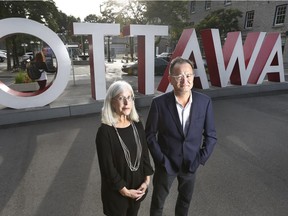 Jill Stoner and Allan Teramura pose in the ByWard Market at the iconic OTTAWA sign.