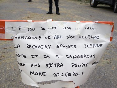 A sign implores non-residents to stay out of Arlington Woods on Sunday morning.
