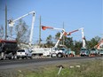 Hydro crews work to restore power in Dunrobin on Monday, following Friday's devastating tornado.